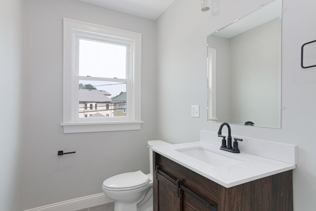 34 Brookvale Street Boston, MA 02124 - Photo 26 of 36 a bathroom with a sink a toilet and a window