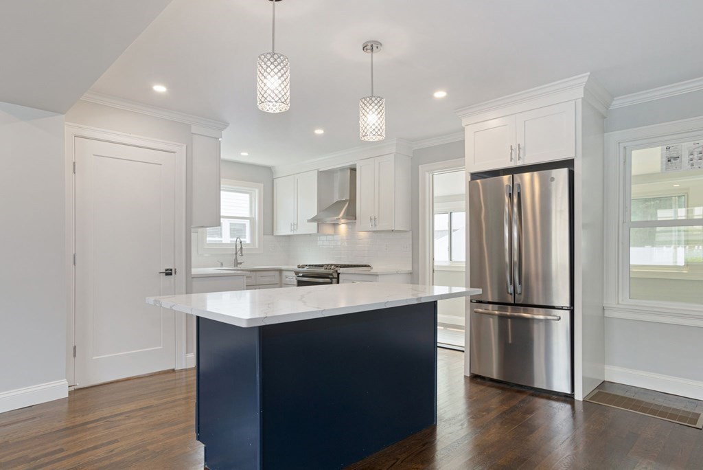 34 Brookvale Street Boston, MA 02124 - Photo 7 of 36 a kitchen with a refrigerator a sink and wooden floor