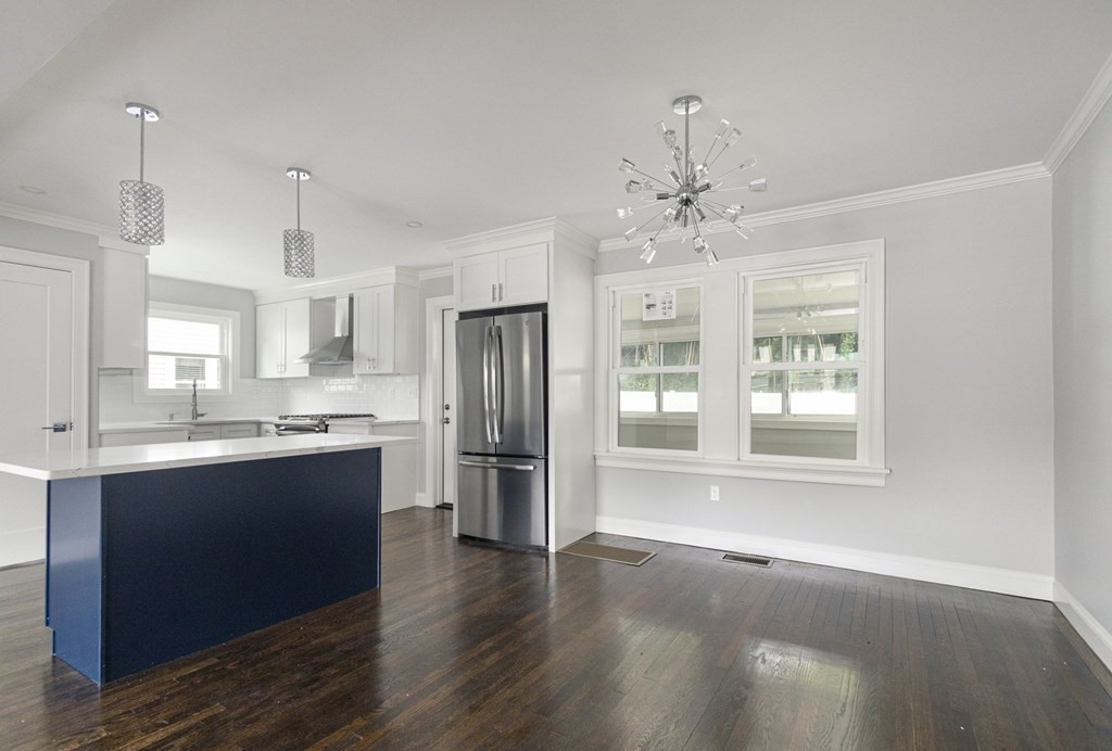 34 Brookvale Street Boston, MA 02124 - Photo 8 of 36 a large kitchen with granite countertop a large counter top space a sink stainless steel appliances and cabinets
