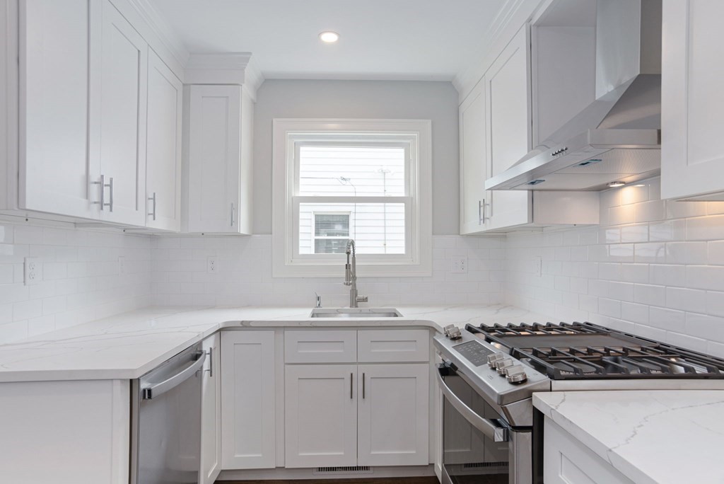34 Brookvale Street Boston, MA 02124 - Photo 9 of 36 a kitchen with white cabinets appliances and a window