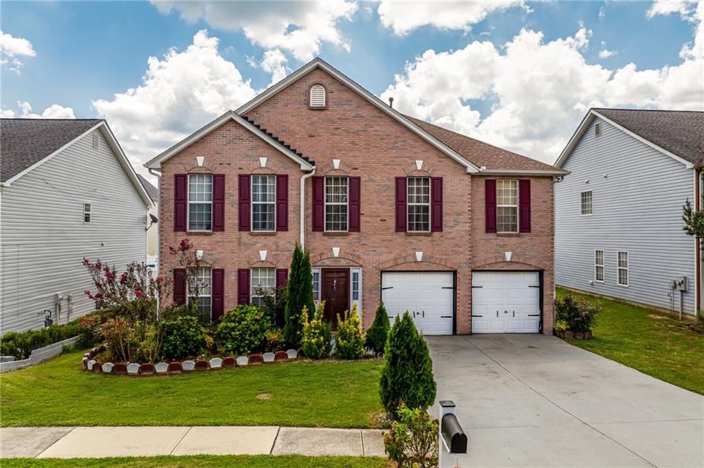 2760 Rusticwood Drive Southwest Snellville, GA 30078 - Photo 1 of 48 a front view of a house with a yard