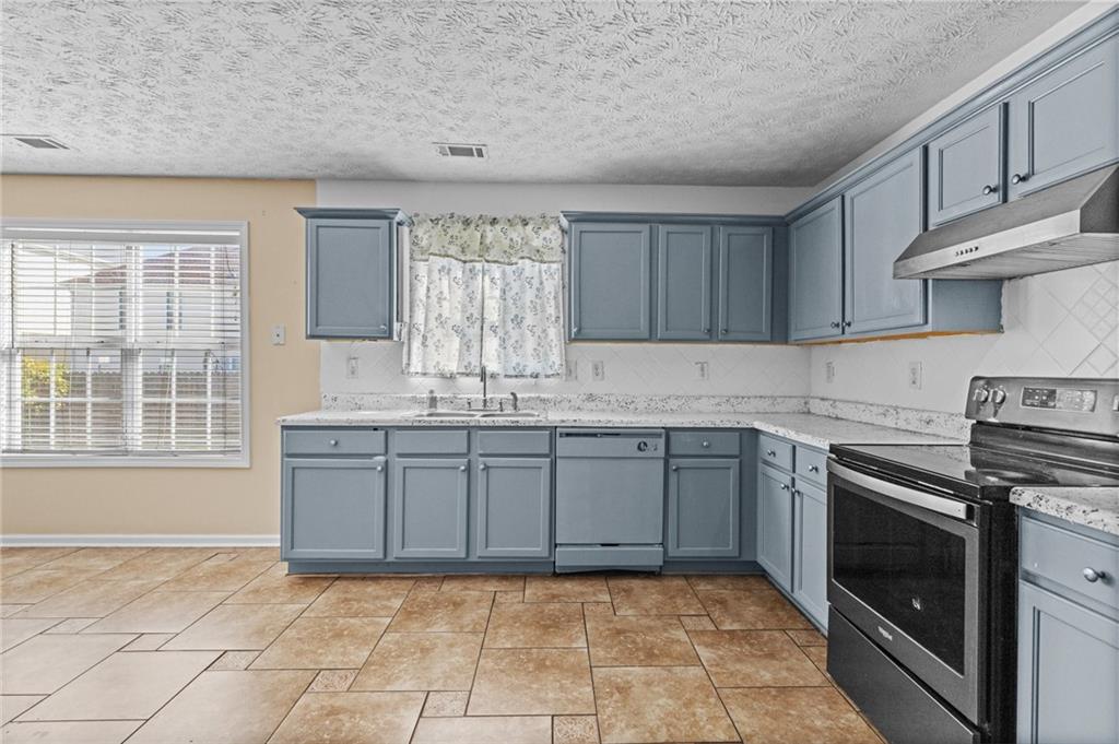 2760 Rusticwood Drive Southwest Snellville, GA 30078 - Photo 18 of 48 a kitchen with a sink stove and cabinets