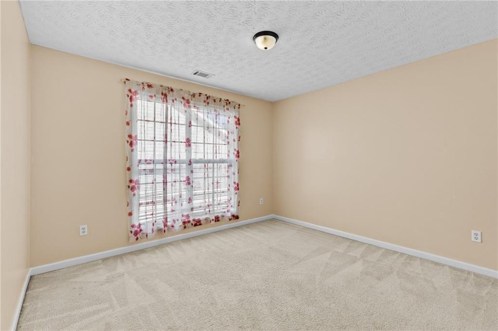 2760 Rusticwood Drive Southwest Snellville, GA 30078 - Photo 35 of 48 an empty room with windows