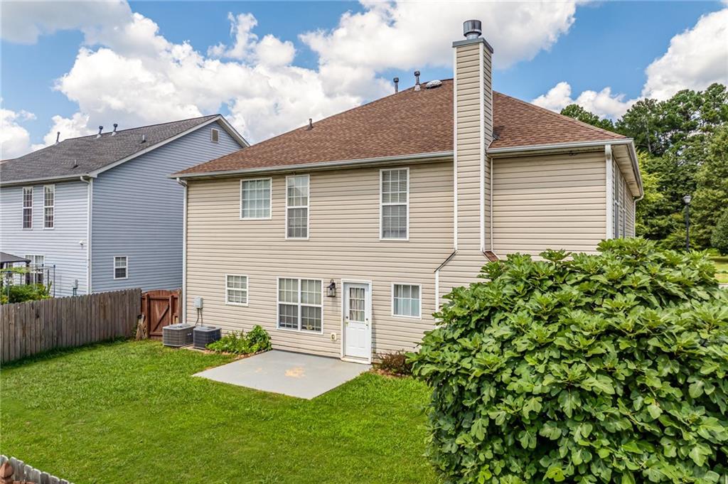 2760 Rusticwood Drive Southwest Snellville, GA 30078 - Photo 45 of 48 a front view of a house with a yard and garage