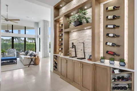 a kitchen with stainless steel appliances a sink a stove and white cabinets