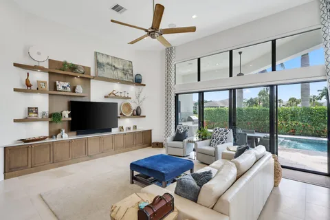 a view of a patio with couches and chairs under an umbrella