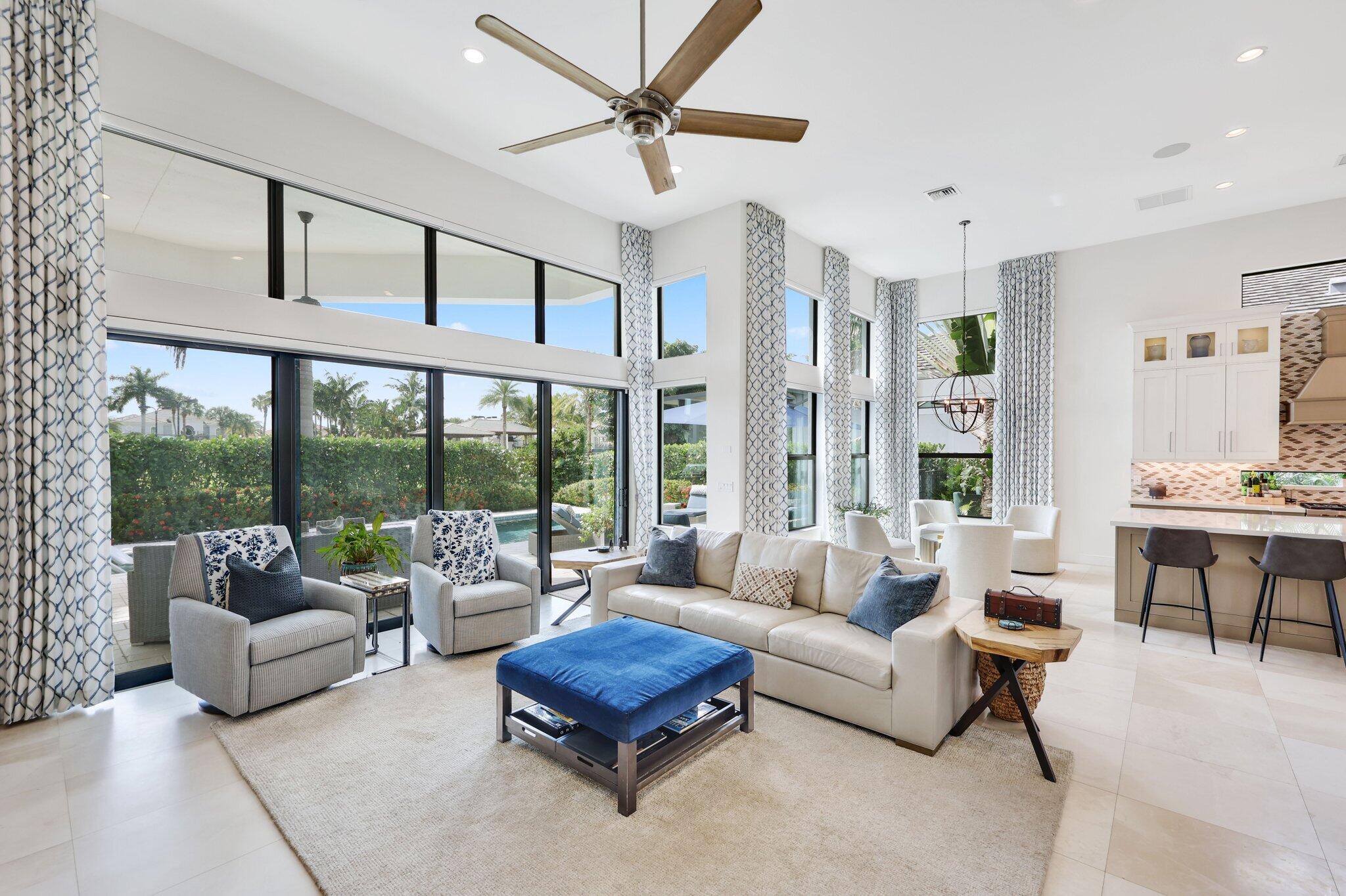2530 Northwest 71st Street Boca Raton, FL 33496 - Photo 15 of 96 a living room with furniture a ceiling fan and a large window