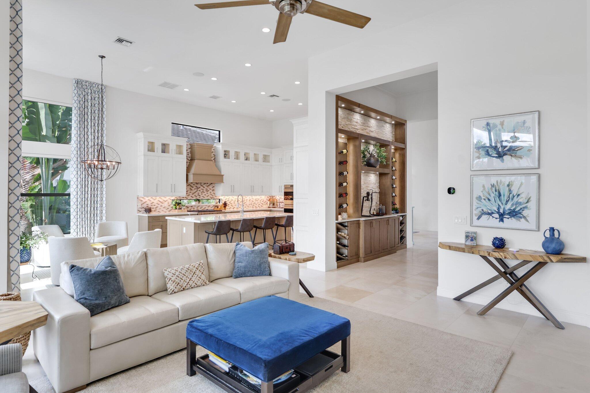 2530 Northwest 71st Street Boca Raton, FL 33496 - Photo 16 of 96 a living room with furniture a rug and a chandelier