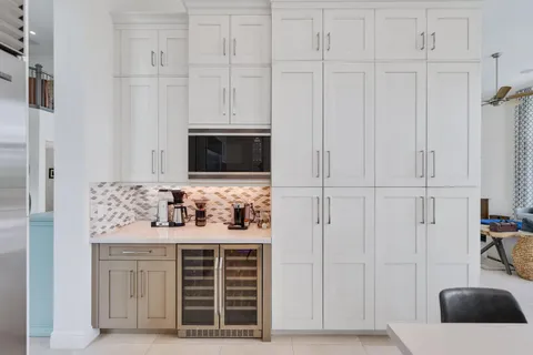 a view of a patio with a table and chairs under an umbrella