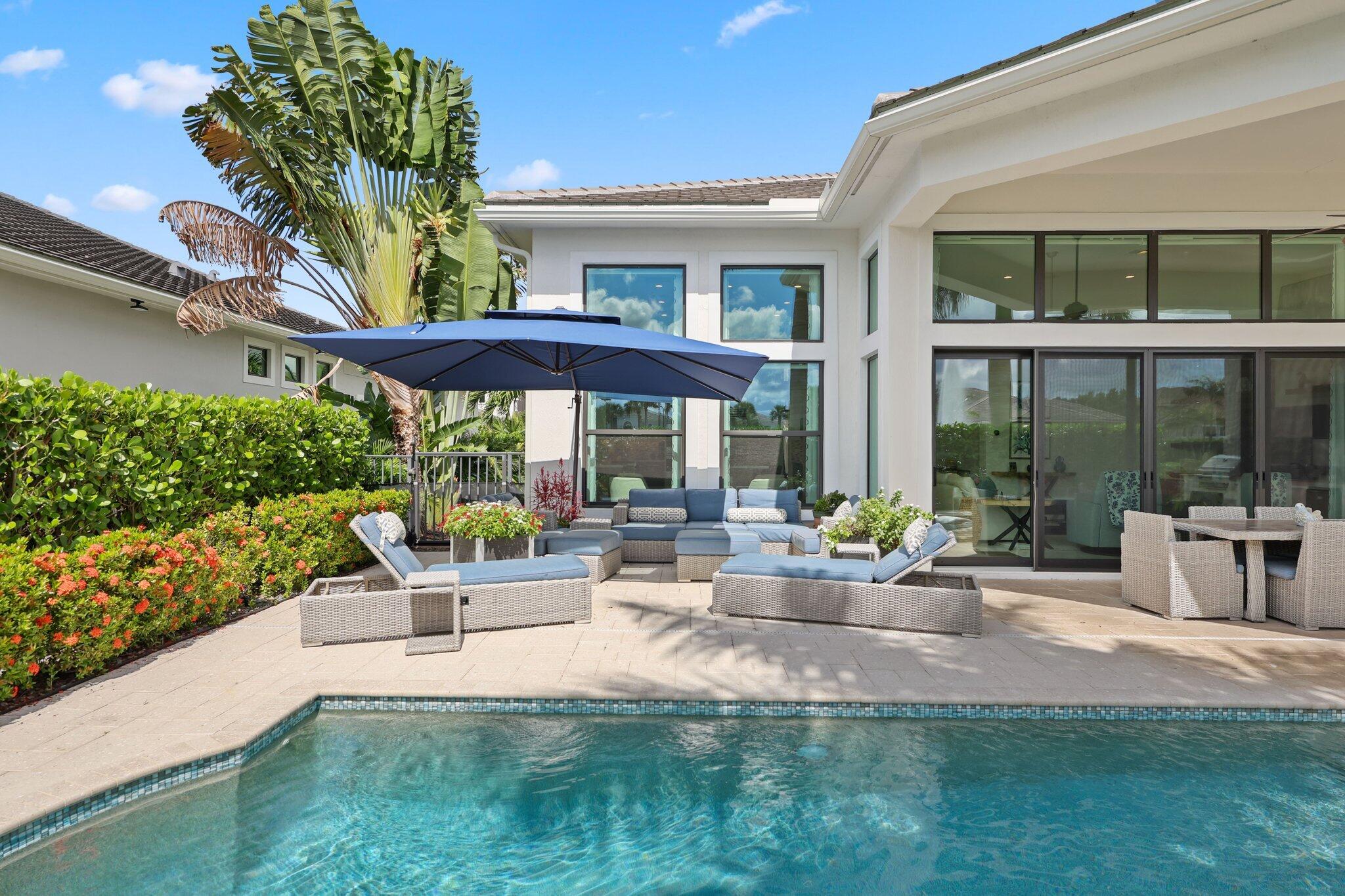 2530 Northwest 71st Street Boca Raton, FL 33496 - Photo 39 of 96 a view of a patio with couches table and chairs and potted plants