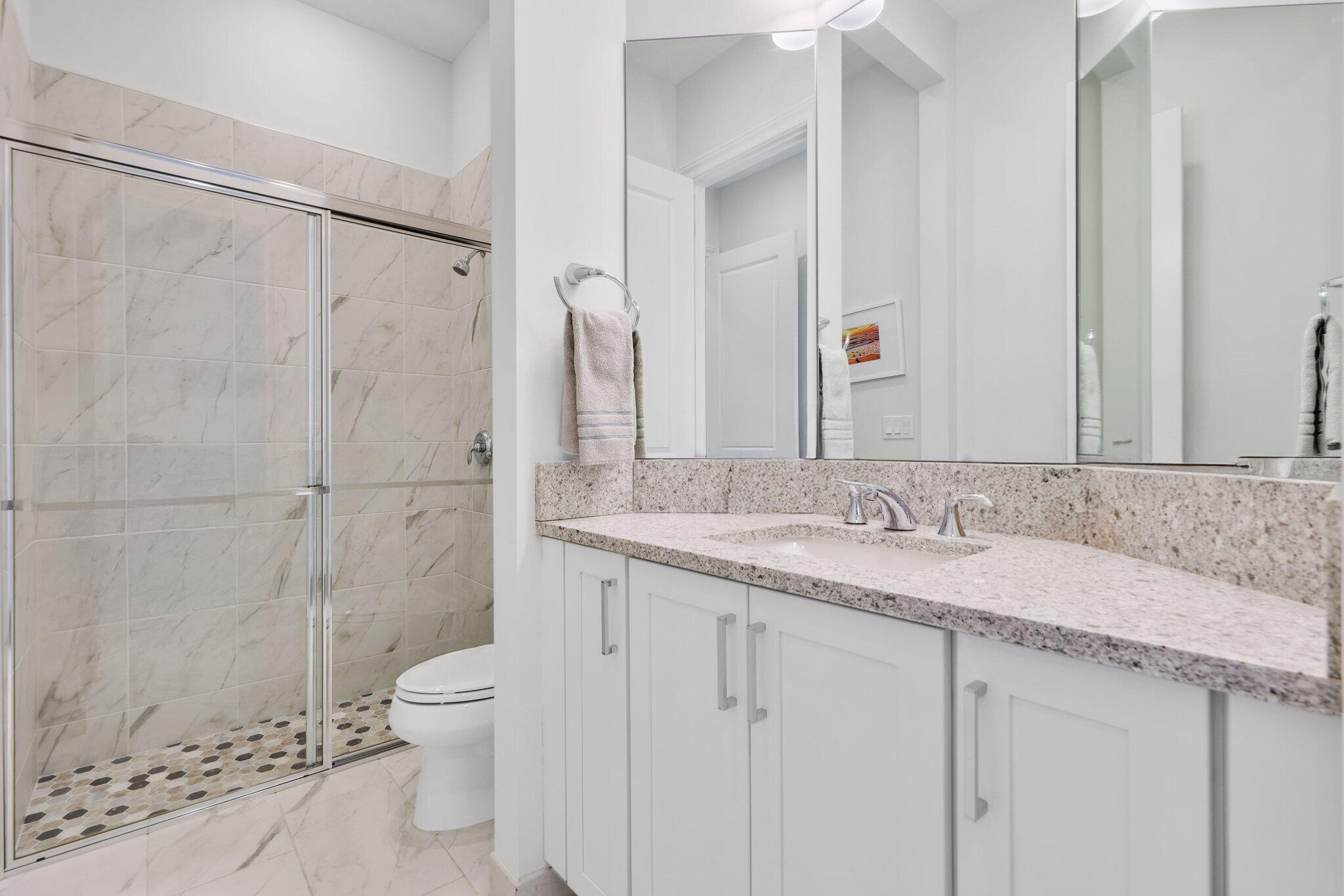 2530 Northwest 71st Street Boca Raton, FL 33496 - Photo 45 of 96 a bathroom with a granite countertop sink toilet and shower