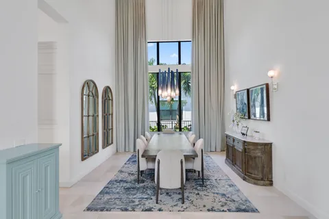 a living room with furniture a rug and a chandelier