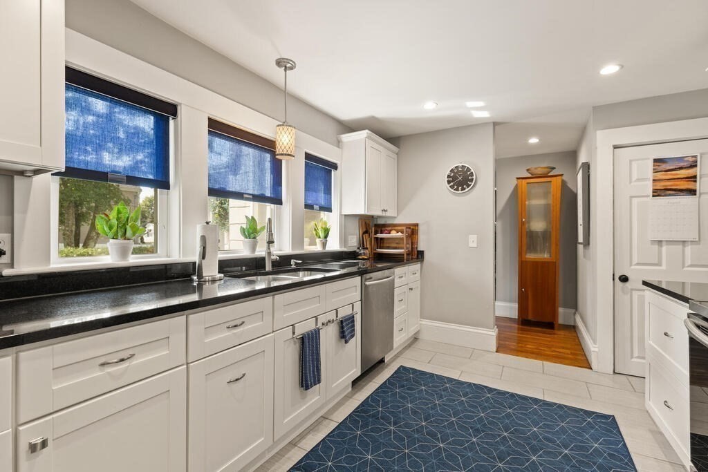 33 Porter Street, Unit 33 Woburn, MA 01801 - Photo 11 of 25 a kitchen with stainless steel appliances granite countertop a refrigerator and a sink