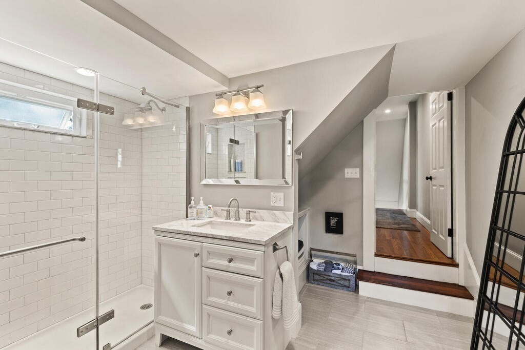 33 Porter Street, Unit 33 Woburn, MA 01801 - Photo 15 of 25 a bathroom with a double vanity sink mirror and shower