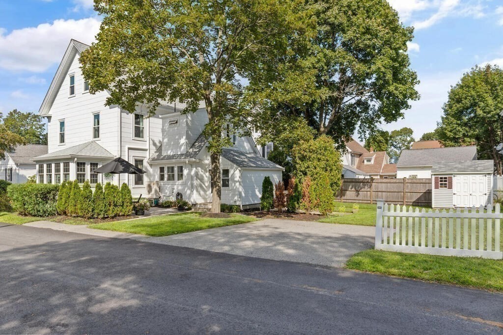 33 Porter Street, Unit 33 Woburn, MA 01801 - Photo 2 of 25 a front view of a house with a yard and garage