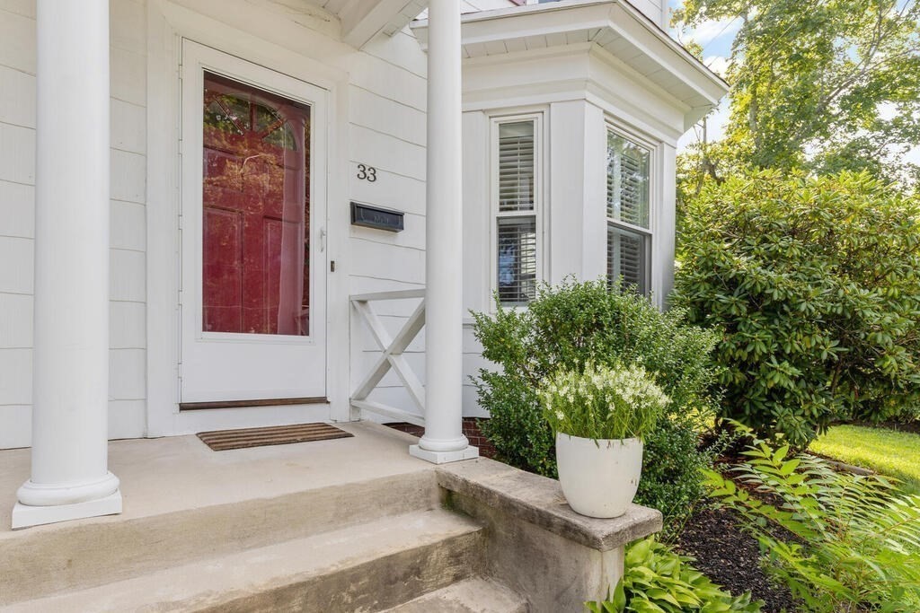33 Porter Street, Unit 33 Woburn, MA 01801 - Photo 3 of 25 a white house with a yard and plants