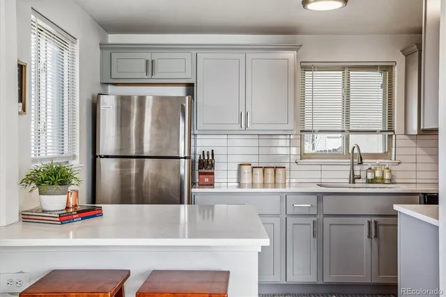 a kitchen with stainless steel appliances granite countertop a refrigerator sink and cabinets