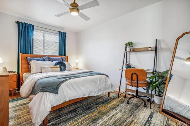 a bedroom with a bed a window and dresser