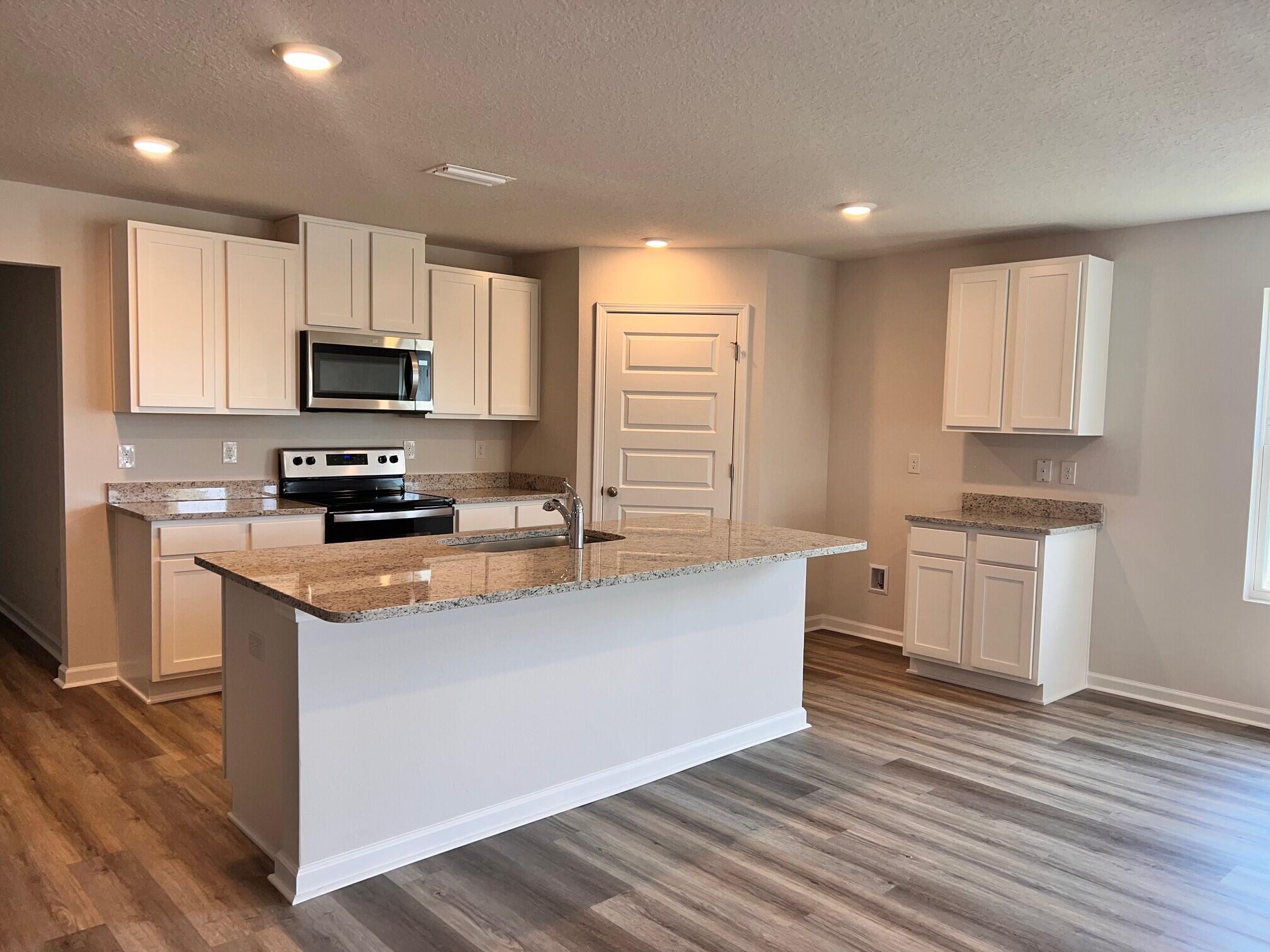 537 Mary Lou Way Crestview, FL 32539 - Photo 7 of 20 a kitchen with stainless steel appliances a microwave a sink a stove a microwave and cabinets