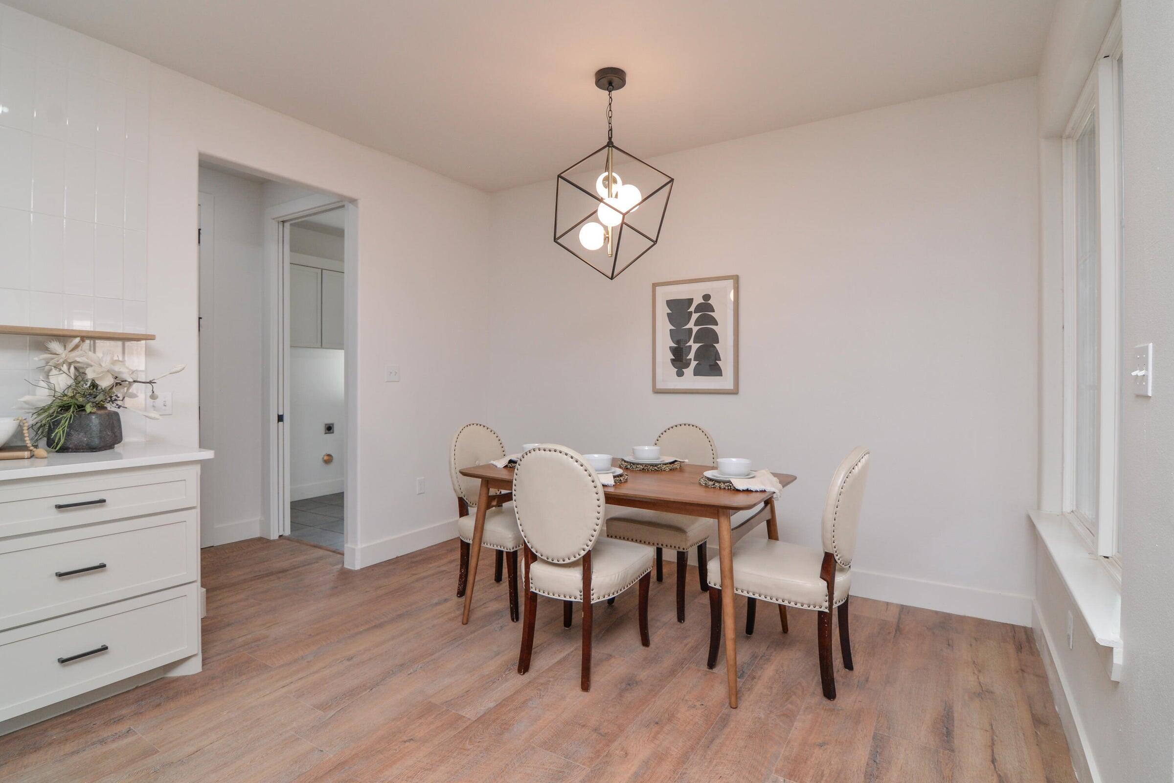 7801 56th Street Lubbock, TX 79407 - Photo 7 of 29 a view of a dining room with furniture and wooden floor