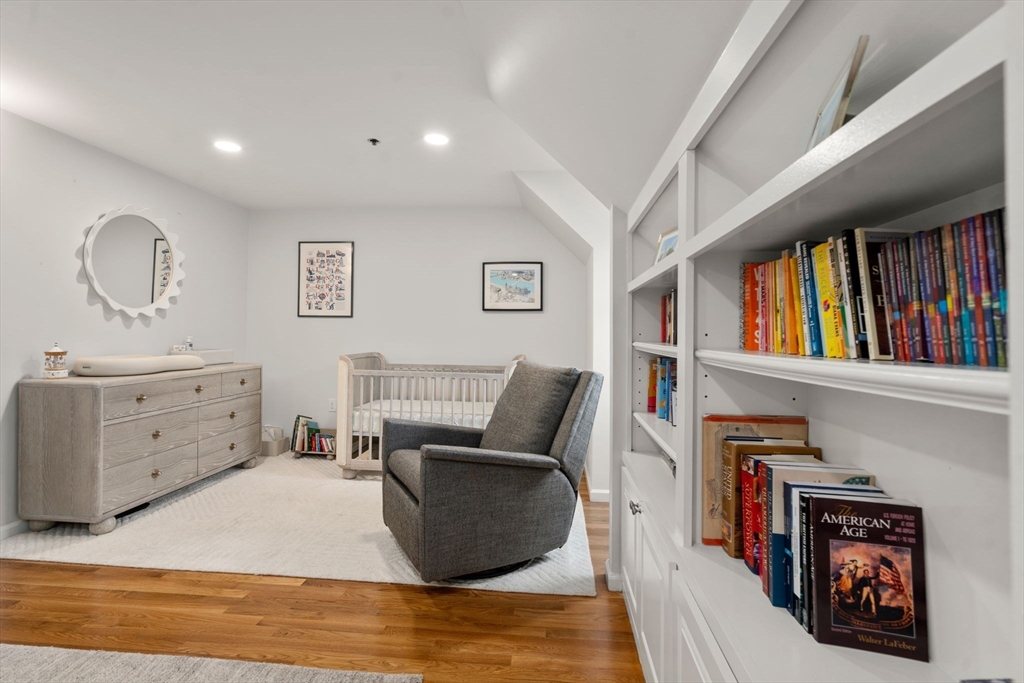 17 Henley Street, Unit F Boston, MA 02129 - Photo 11 of 19 a living room with furniture a rug and a book shelf