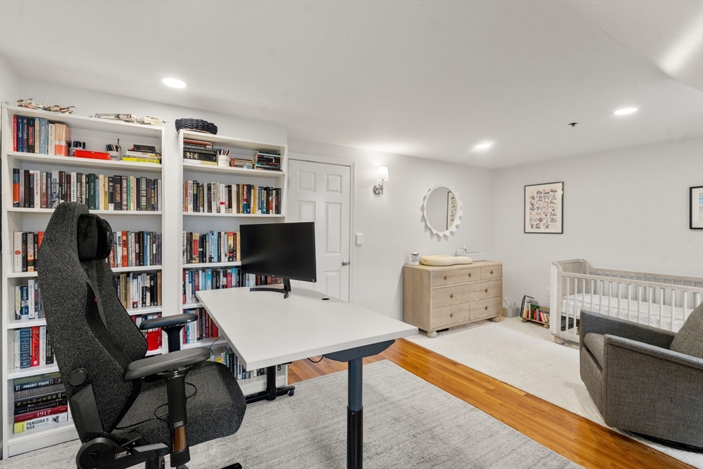 17 Henley Street, Unit F Boston, MA 02129 - Photo 12 of 19 a bedroom with furniture and a book shelf