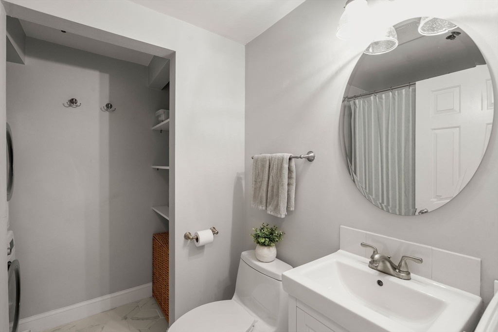17 Henley Street, Unit F Boston, MA 02129 - Photo 15 of 19 a bathroom with a sink toilet and mirror