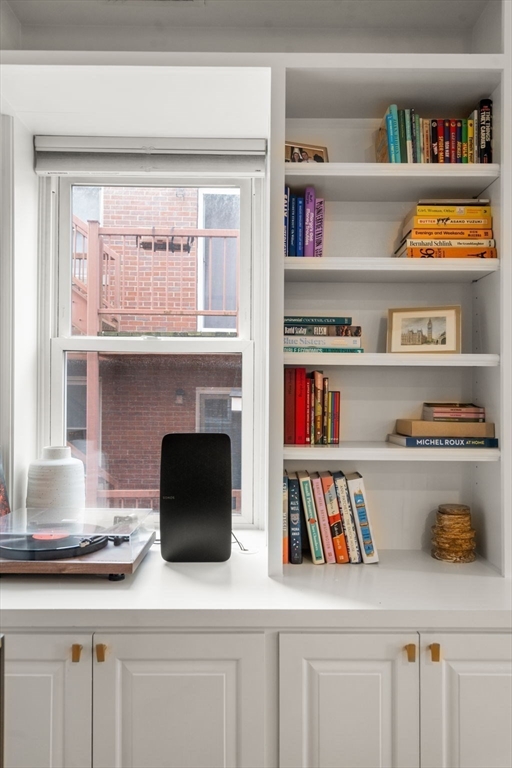 17 Henley Street, Unit F Boston, MA 02129 - Photo 4 of 19 a room with a book shelf and a wooden floor