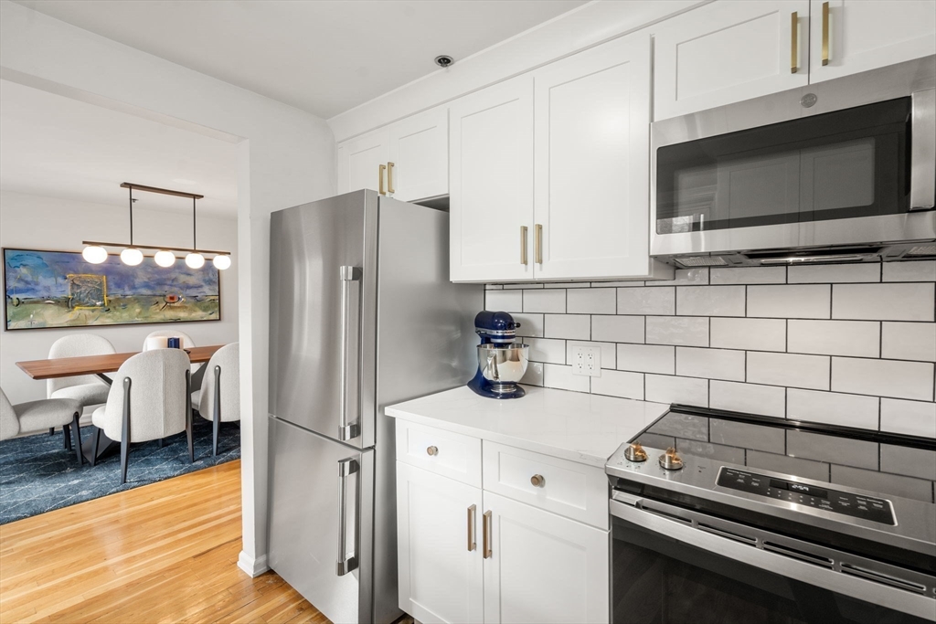 17 Henley Street, Unit F Boston, MA 02129 - Photo 6 of 19 a kitchen with a stove a sink and a refrigerator
