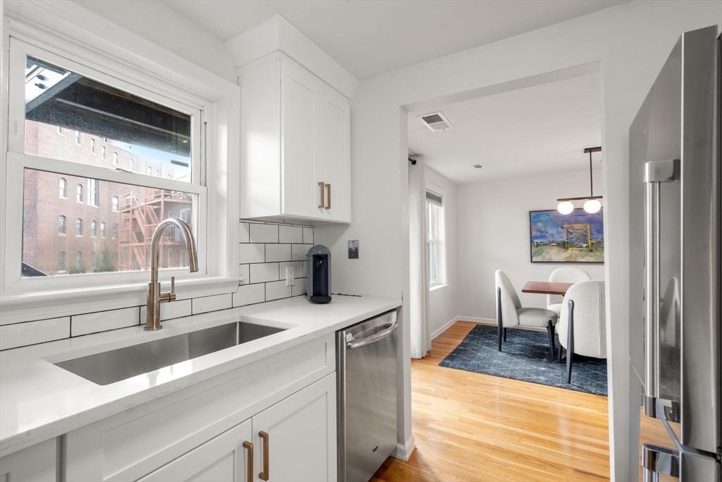 17 Henley Street, Unit F Boston, MA 02129 - Photo 7 of 19 a kitchen with a sink cabinets and wooden floor