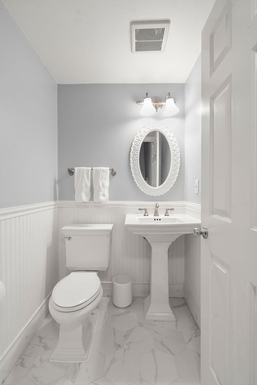 17 Henley Street, Unit F Boston, MA 02129 - Photo 8 of 19 a bathroom with a sink a toilet and a mirror