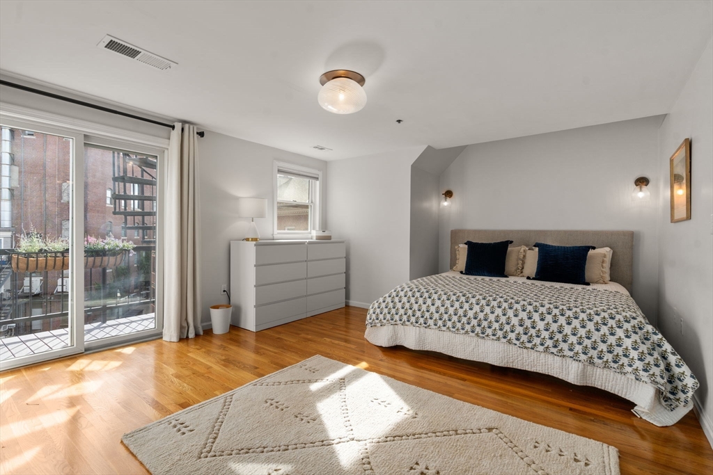 17 Henley Street, Unit F Boston, MA 02129 - Photo 9 of 19 a bedroom with a large bed and a view of bedroom