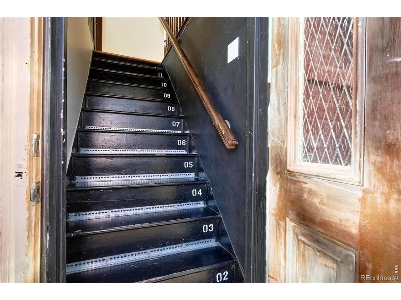 2929 Curtis Street Denver, CO 80205 - Photo 17 of 43 This staircase can access both units to return the property to a single family home, if desired.