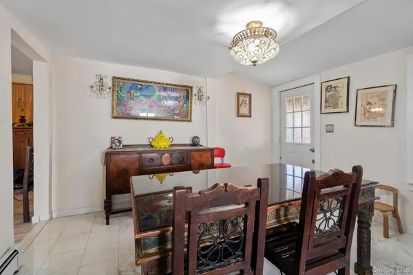 a view of a dining room with furniture and chandelier