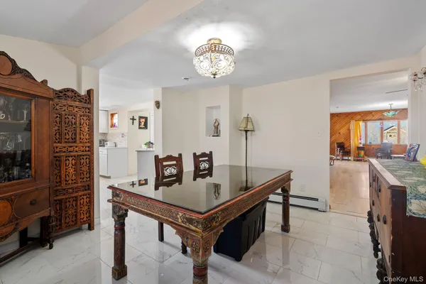 a room with furniture a chandelier and a table