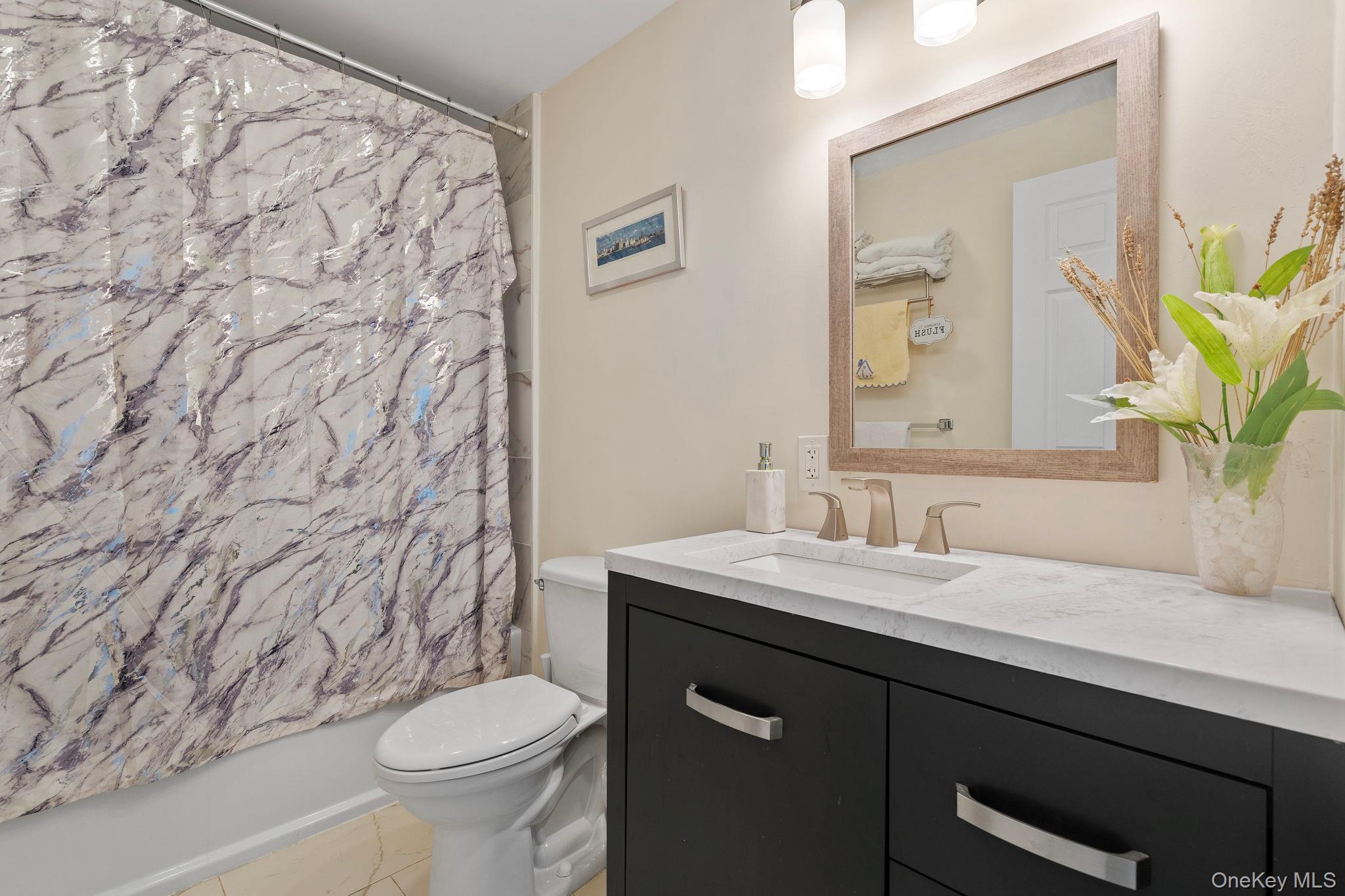 18-20 Spring Street Port Jervis, NY 12771 - Photo 16 of 46 a bathroom with a granite countertop sink and a toilet