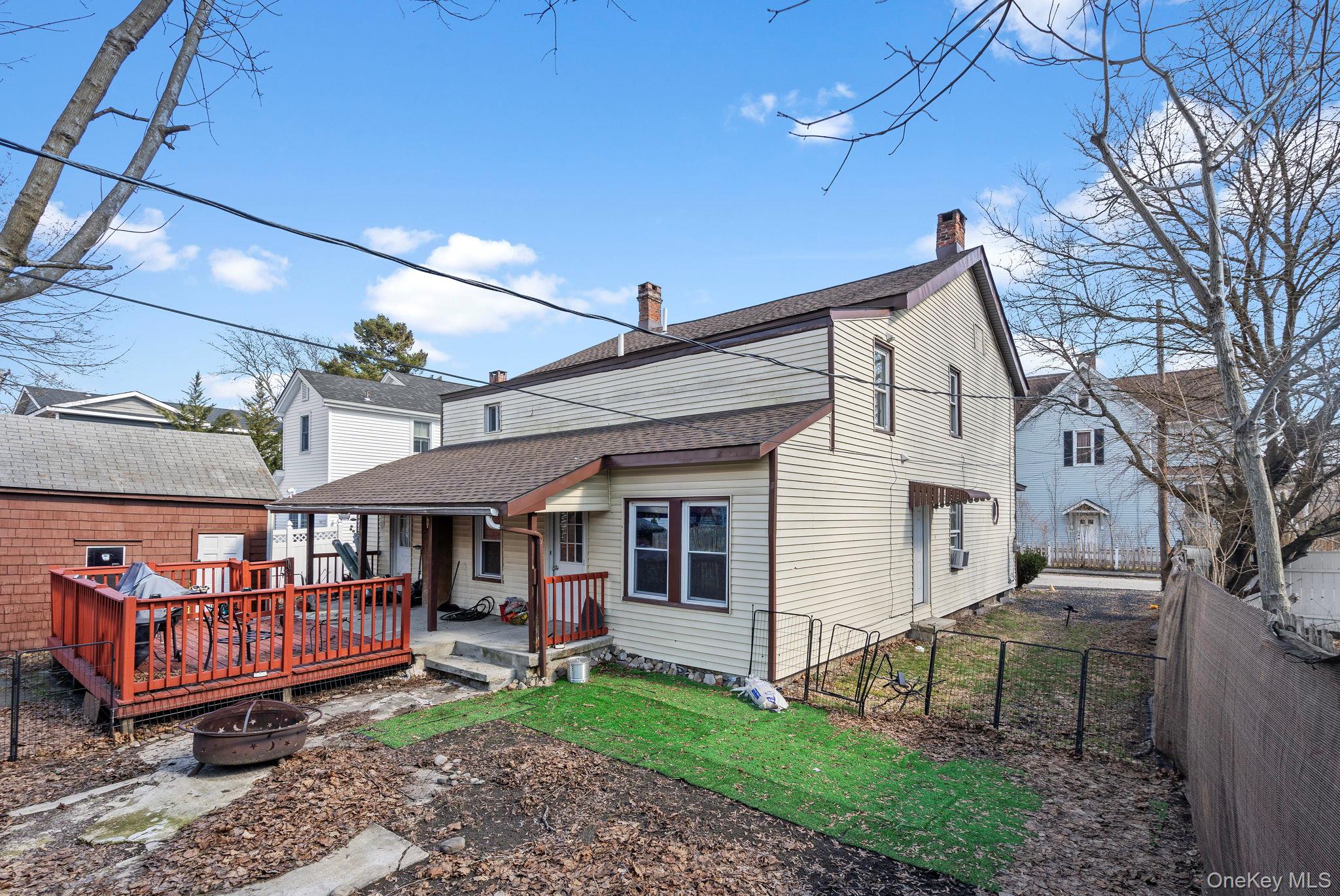 18-20 Spring Street Port Jervis, NY 12771 - Photo 2 of 46 a view of a house with a yard and wooden fence