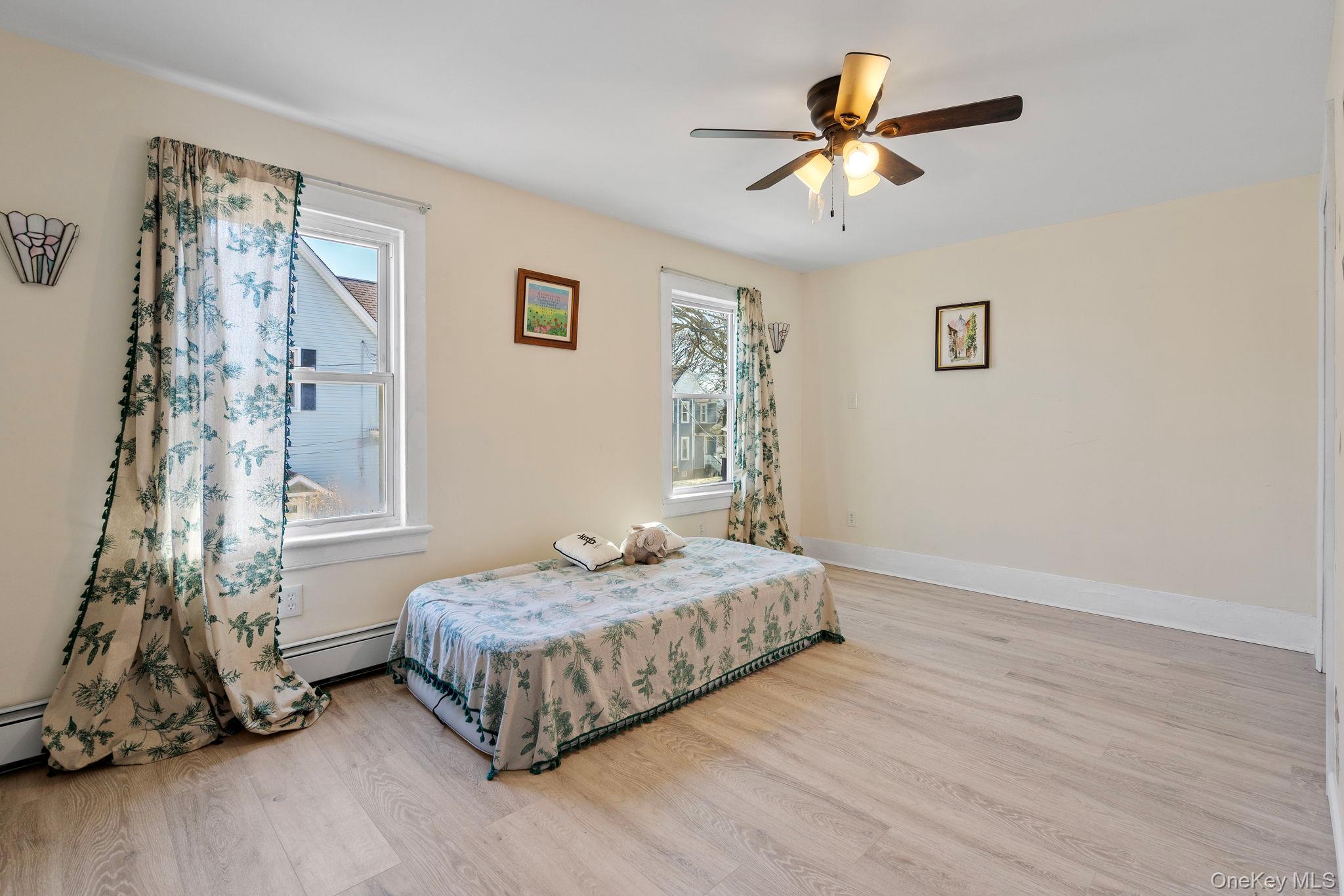18-20 Spring Street Port Jervis, NY 12771 - Photo 26 of 46 a spacious bedroom with a bed and a chandelier