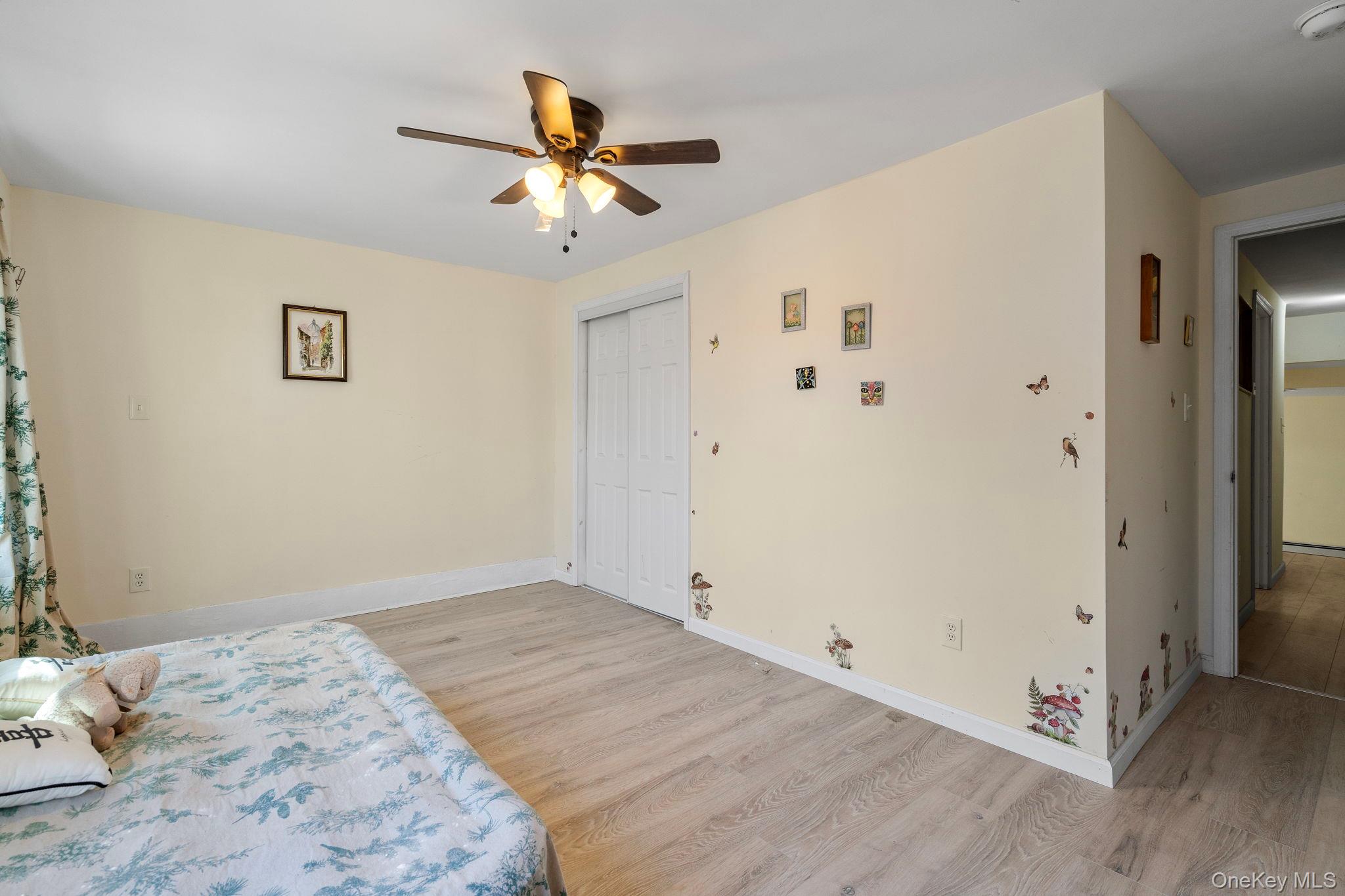18-20 Spring Street Port Jervis, NY 12771 - Photo 27 of 46 a view of a bedroom with a bed and wooden floor
