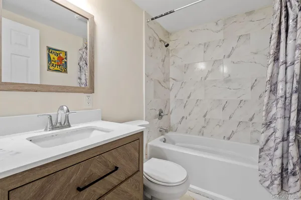 a bathroom with a sink a toilet and bathtub