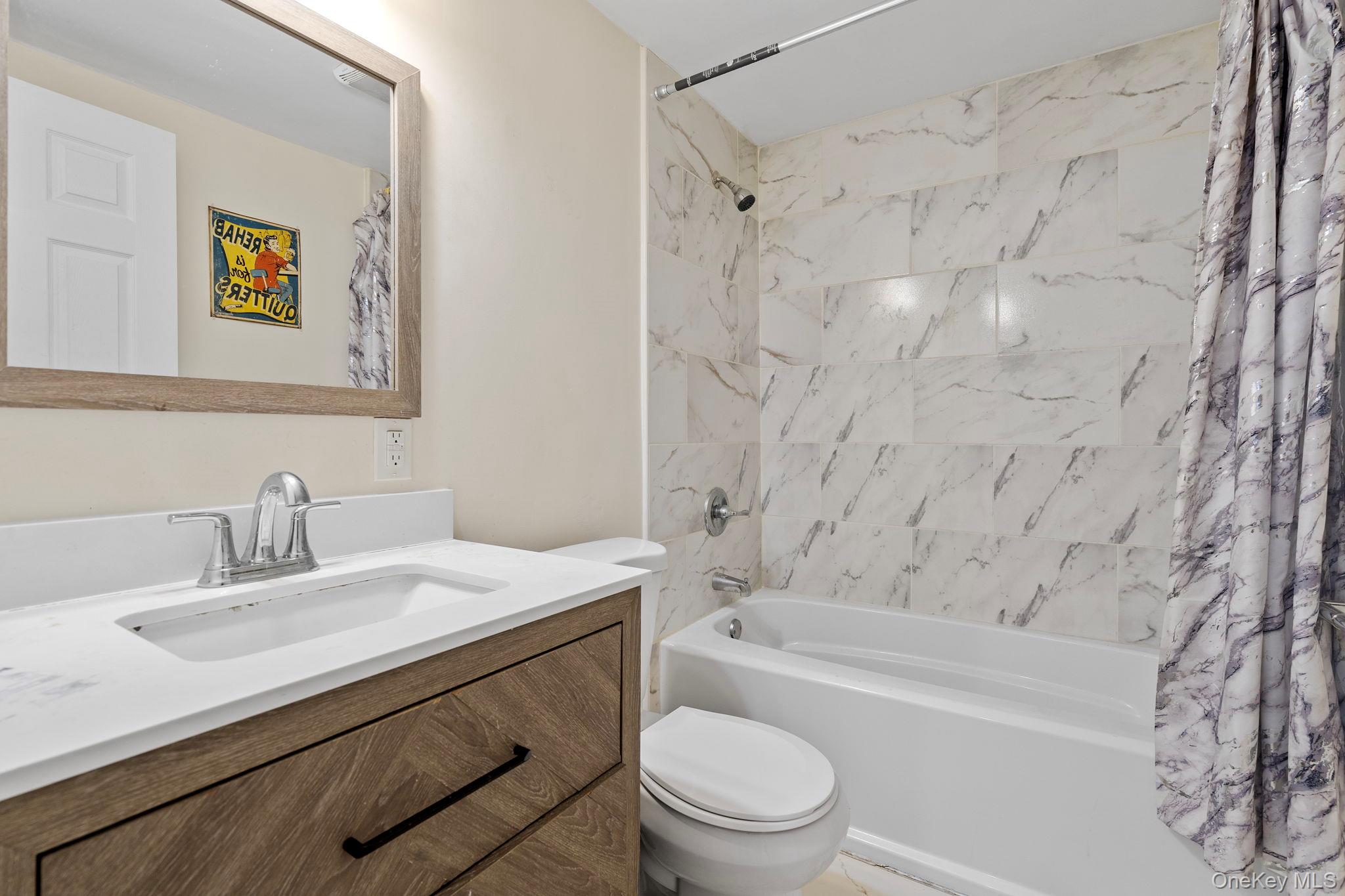 18-20 Spring Street Port Jervis, NY 12771 - Photo 32 of 46 a bathroom with a sink a toilet and bathtub