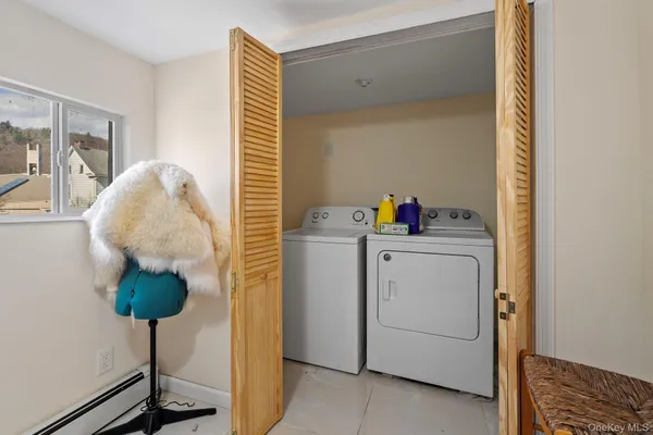 a bath room with a washer and dryer