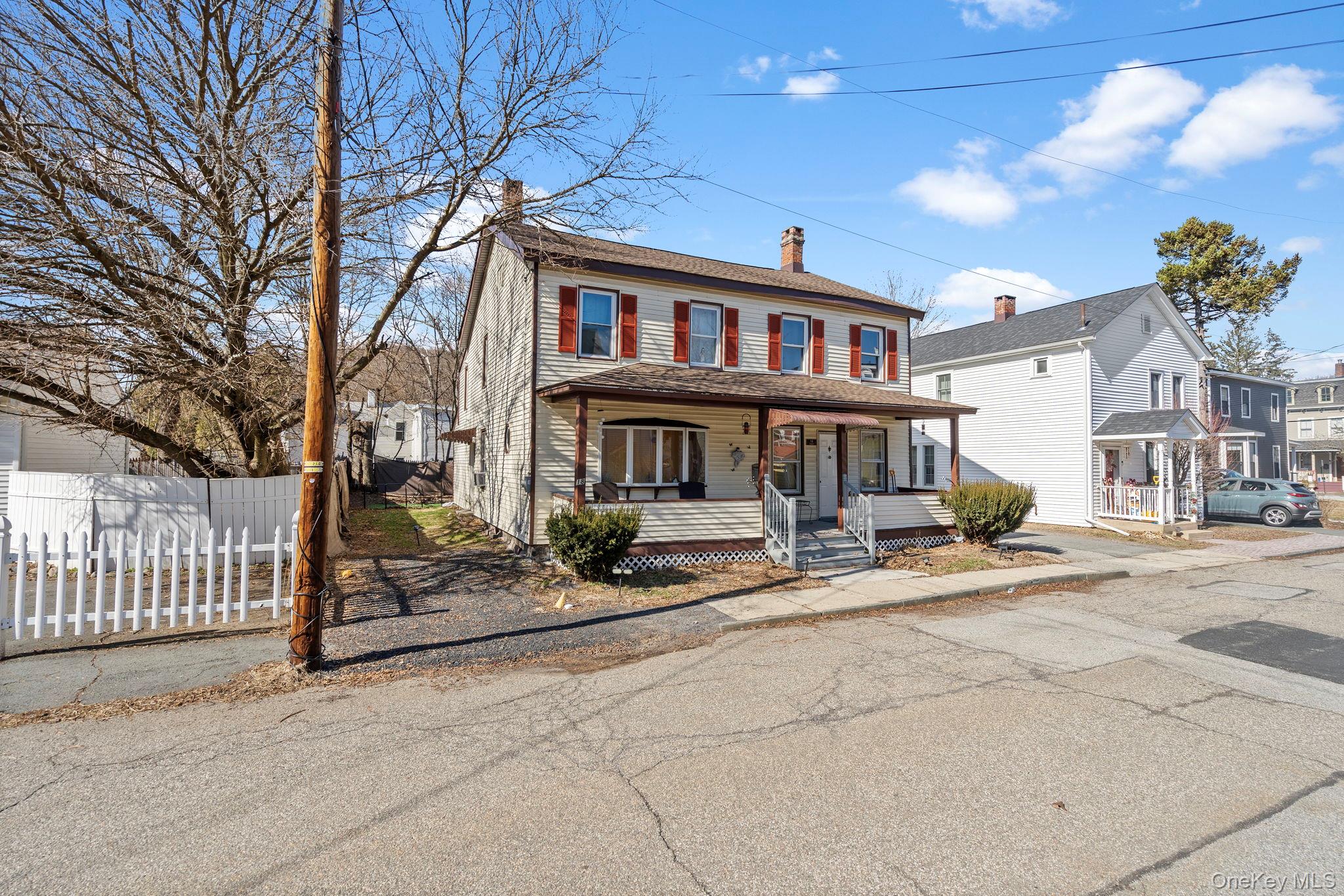 18-20 Spring Street Port Jervis, NY 12771 - Photo 36 of 46 a front view of a residential apartment building with a yard