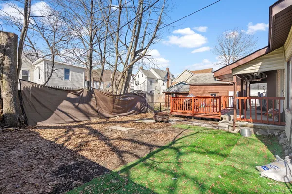 a backyard of a house with barbeque oven table and chairs