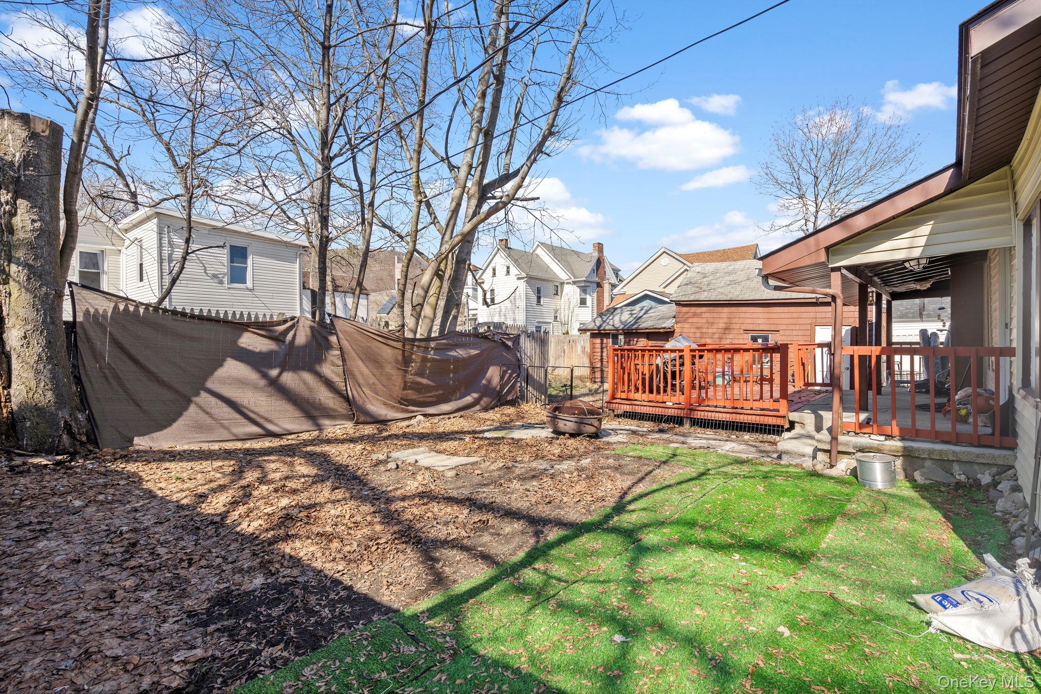 18-20 Spring Street Port Jervis, NY 12771 - Photo 41 of 46 a backyard of a house with barbeque oven table and chairs