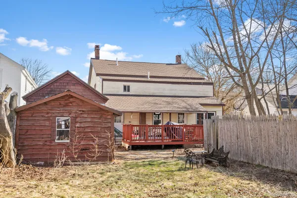 a view of a house with a large window and a yard