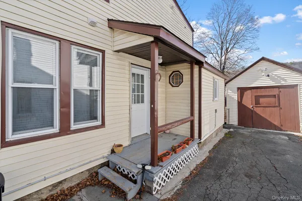 a front view of a house with parking area