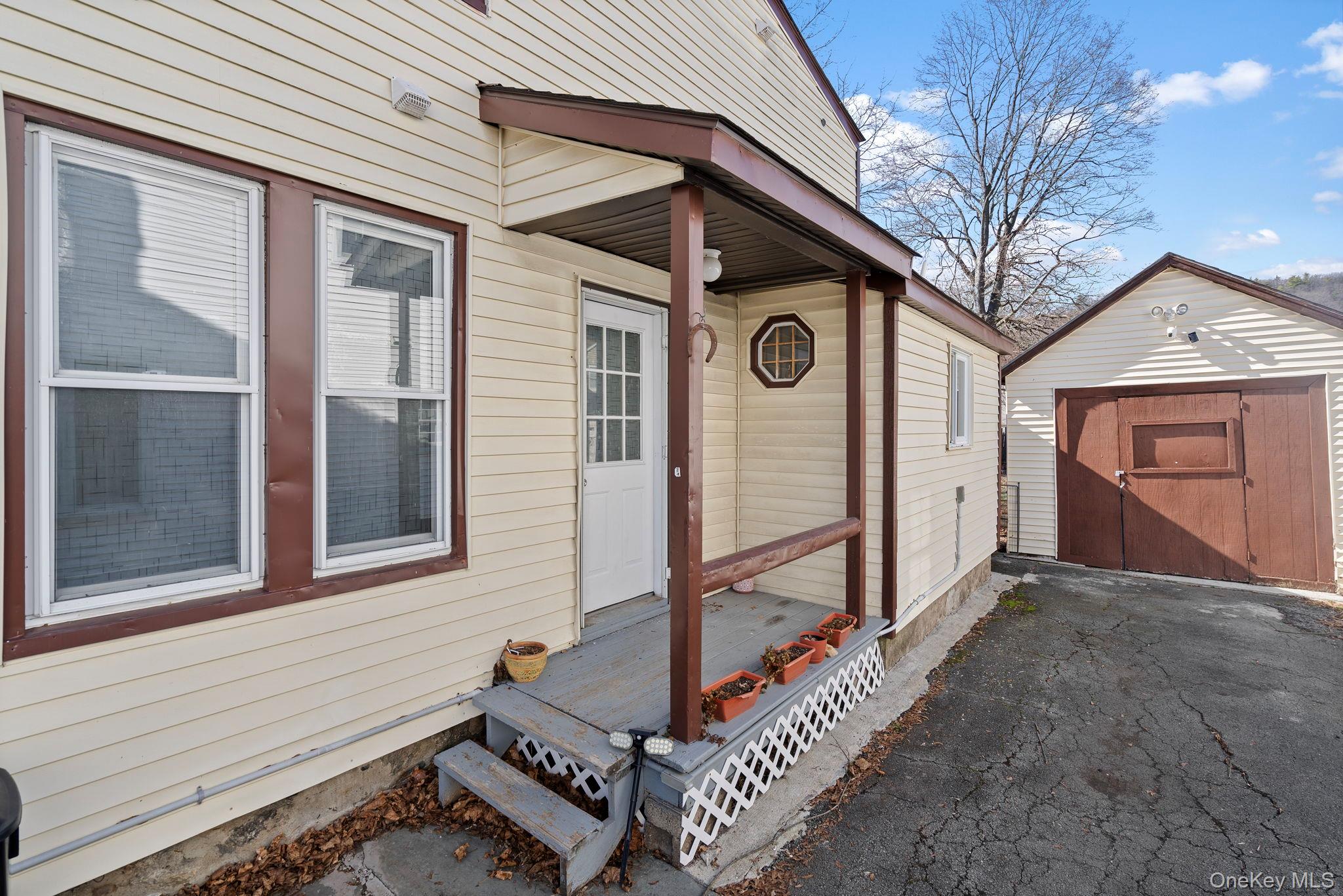 18-20 Spring Street Port Jervis, NY 12771 - Photo 45 of 46 a front view of a house with parking area