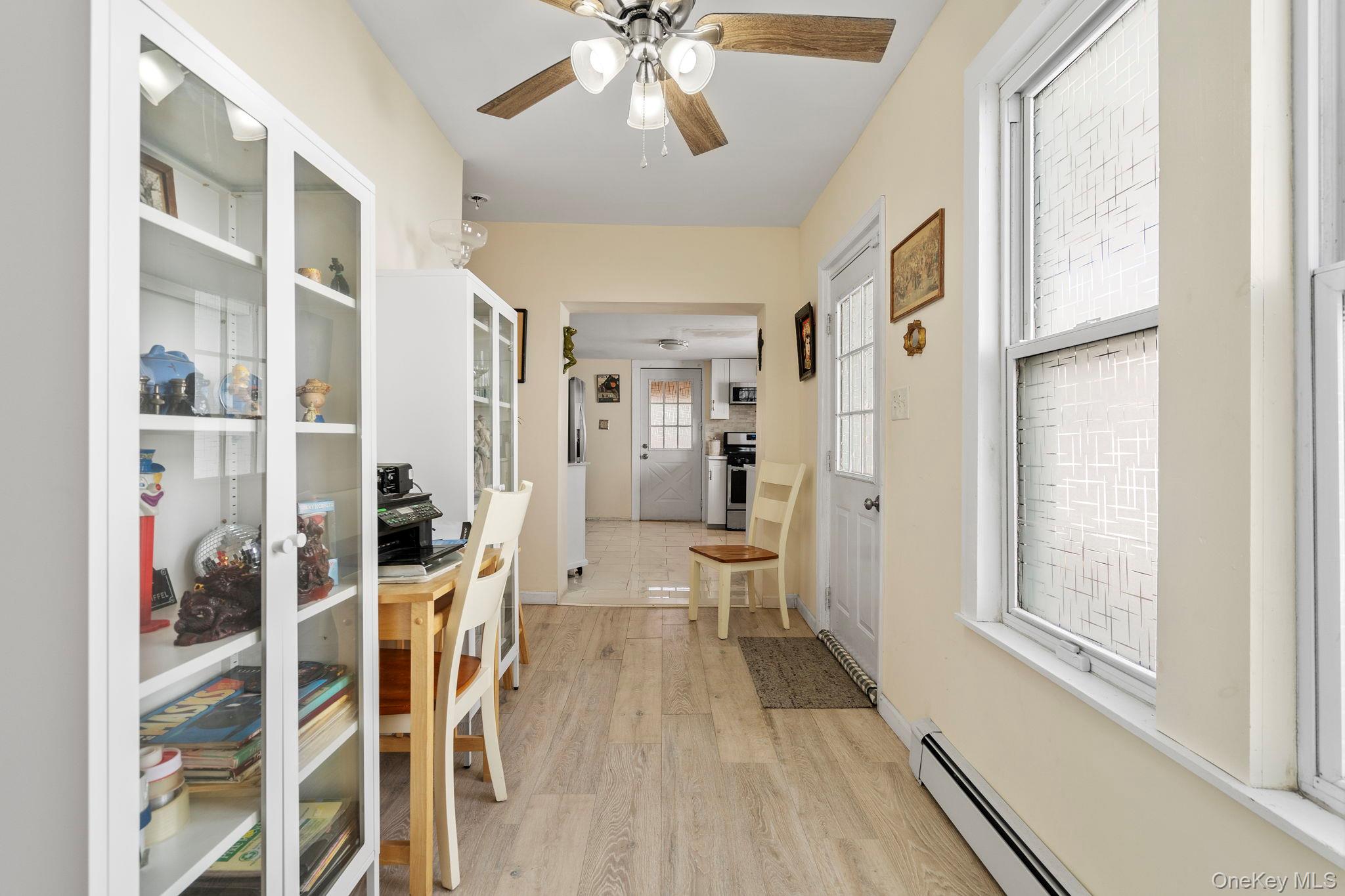 18-20 Spring Street Port Jervis, NY 12771 - Photo 7 of 46 a view of a hallway with wooden floor and a living room