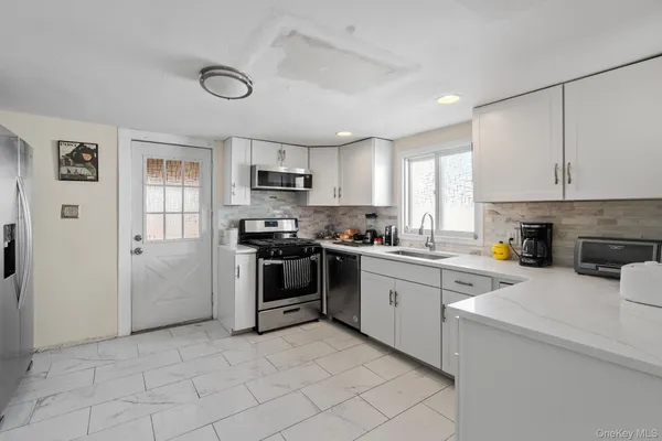 a kitchen with a sink cabinets and stainless steel appliances